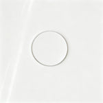 Close-up of the color-matched drain in the glossy white bathtub.