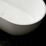 Close-up of the thin rim and rounded exterior of the solid surface bathtub.