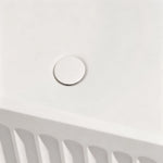 Close-up of the color-matched drain inside the fluted bathtub.