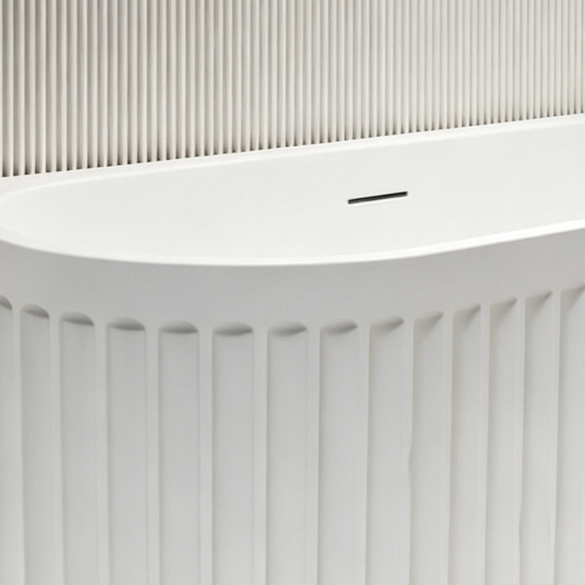Close-up of the slot overflow above the curved fluted front panel.
