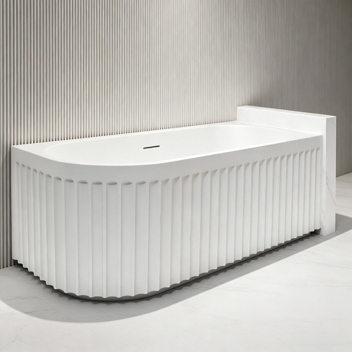 Side-angle view of the curved-front fluted back-to-wall bathtub.