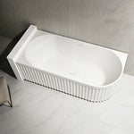 Top view of the fluted bathtub installed against a ribbed wall.