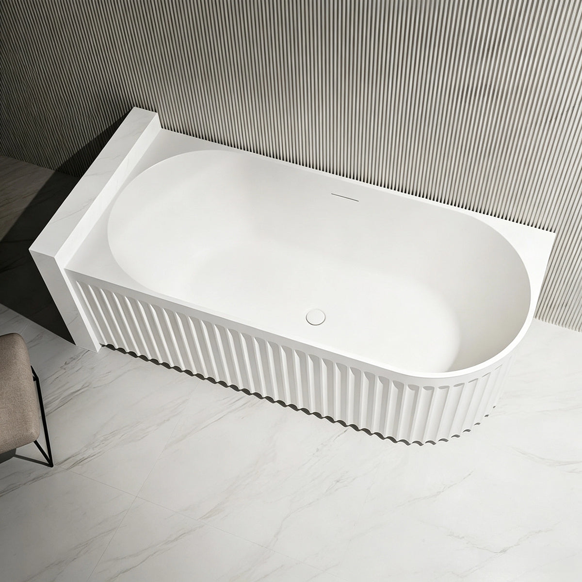 Top view of the fluted bathtub installed against a ribbed wall.