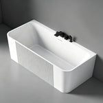 Angled view of the fluted-panel bathtub installed against a wall.
