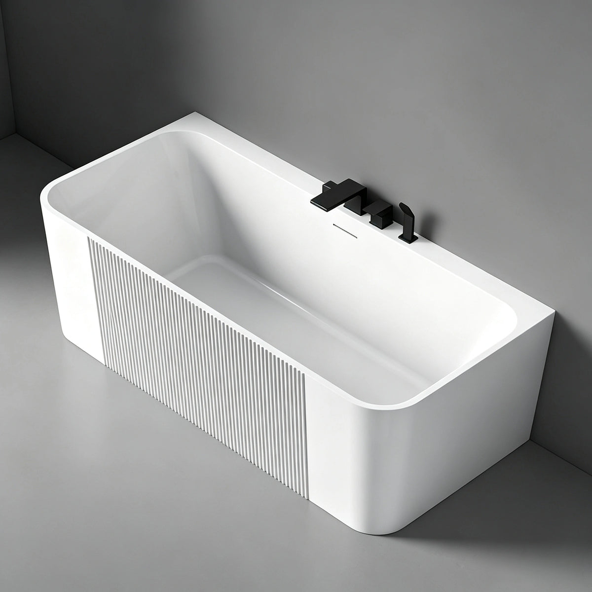Angled view of the fluted-panel bathtub installed against a wall.