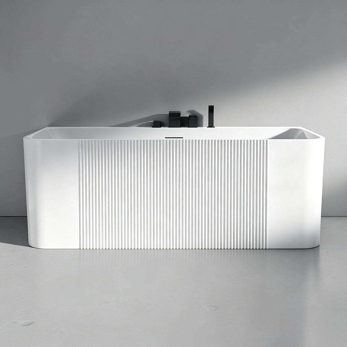 Front view of the glossy white bathtub with a centered fluted panel.