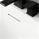 Close-up of the slot overflow and black deck-mounted faucet.