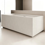 Angled view of the rectangular fluted bathtub installed against a wall.