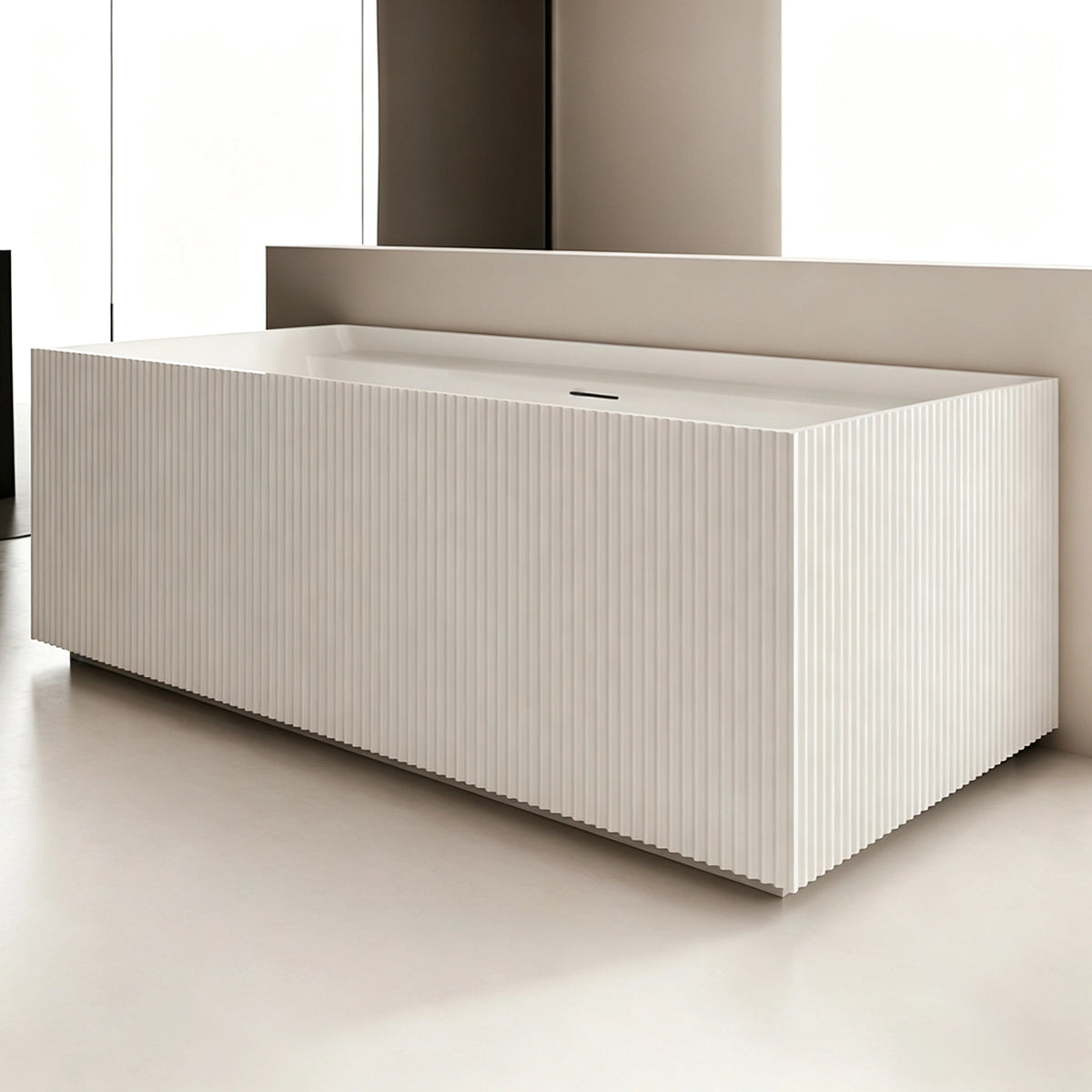 Angled view of the rectangular fluted bathtub installed against a wall.