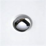 Close-up of the chrome drain inside the acrylic bathtub.