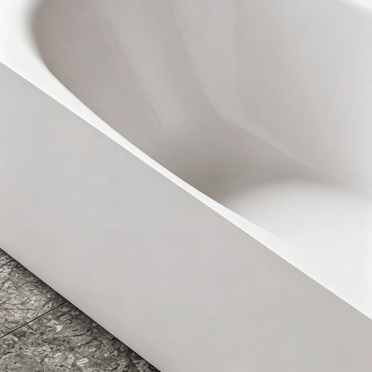 Close-up of the sloped oval basin inside the wide-rim bathtub.