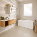 Wide-rim rectangular freestanding bathtub in a bright modern bathroom.