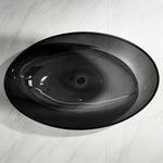 Top view into the oval basin of the transparent black resin bathtub.