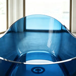 Interior view showing the drain and high curved ends of the blue bathtub.