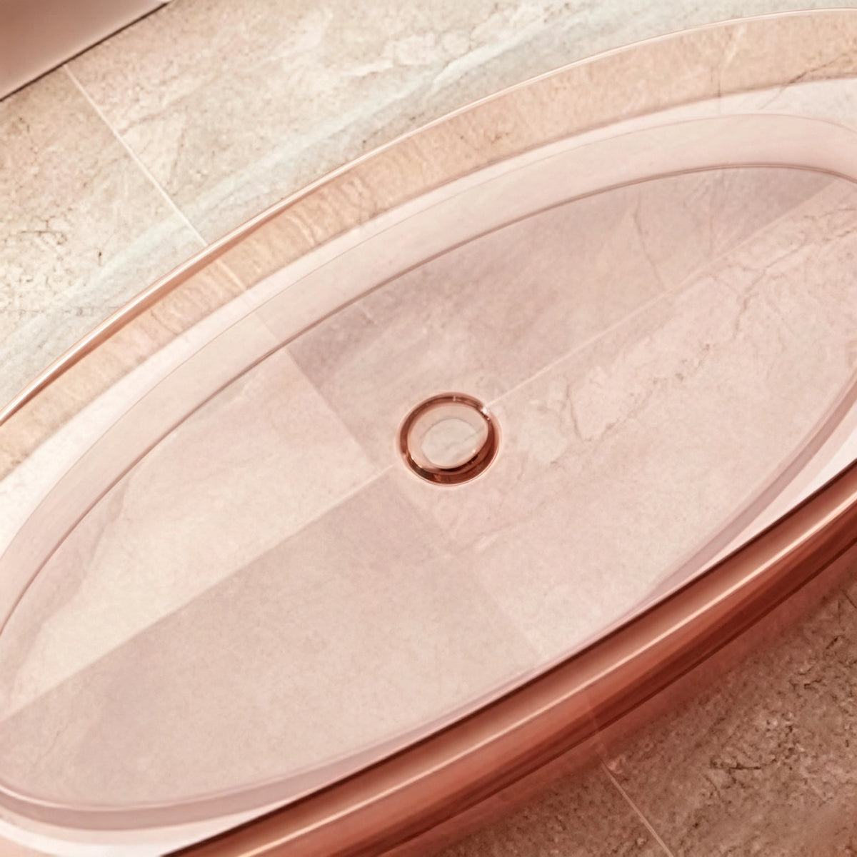 Close-up of the drain inside the transparent pink oval bathtub.