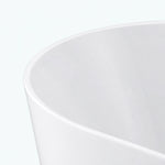 Close-up of smooth glossy rim of freestanding soaking bathtub