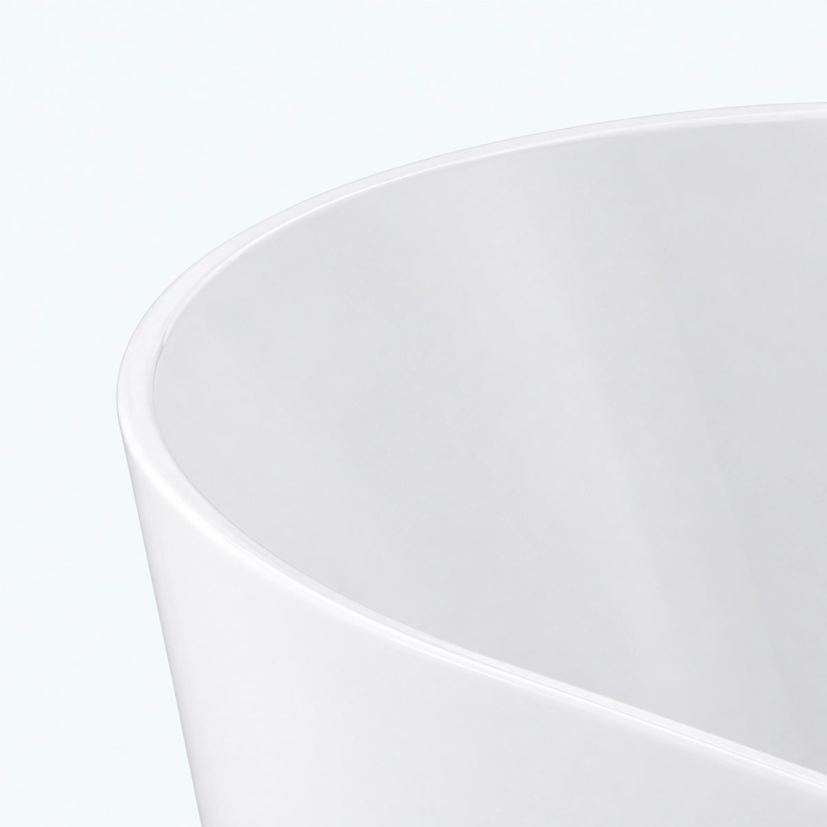 Close-up of smooth glossy rim of freestanding soaking bathtub