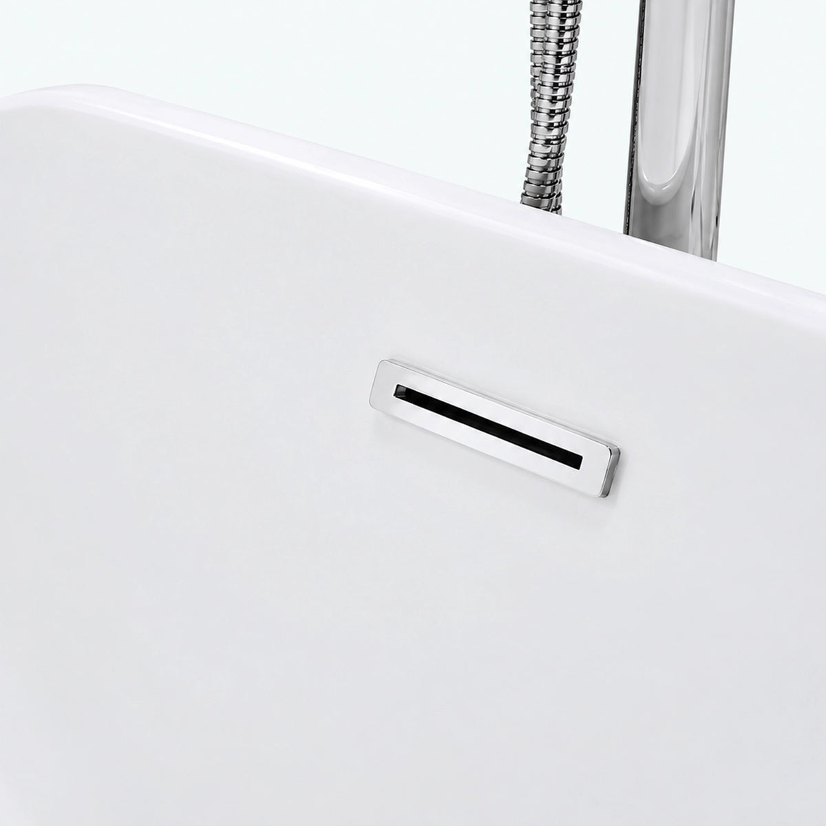 Close-up of built-in overflow cover on white freestanding tub