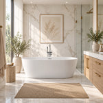 White oval freestanding tub in marble bathroom