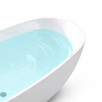 Partial shot of smooth white acrylic tub rim and curved bath wall