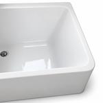 Interior close-up of rectangular bathtub with rounded inner corner and drain