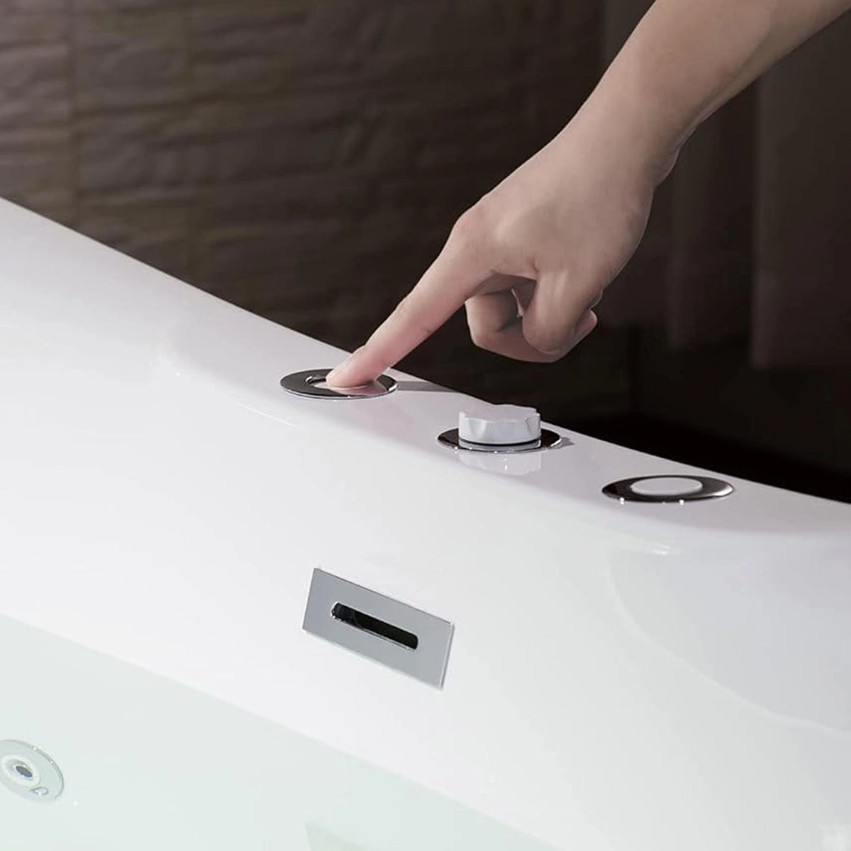 Close-up of bathtub control panel, hand pressing operation button