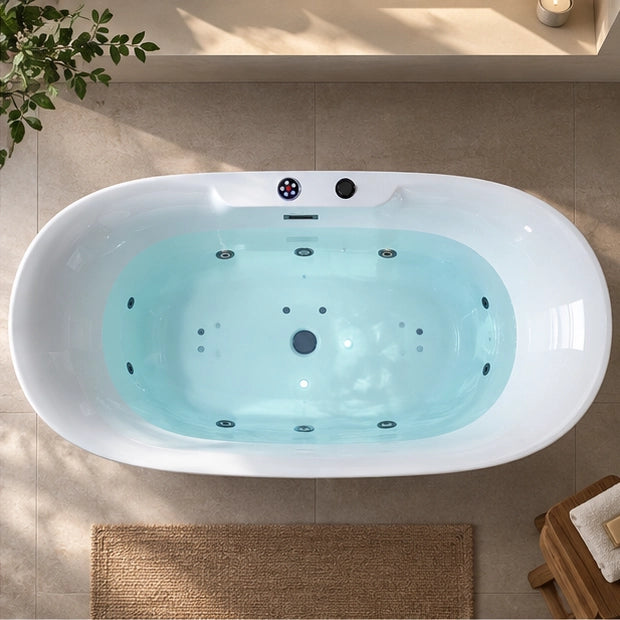 Top view of oval jetted freestanding bathtub filled with water in bright bathroom