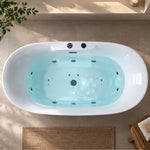 Top view of oval jetted freestanding bathtub filled with water in bright bathroom