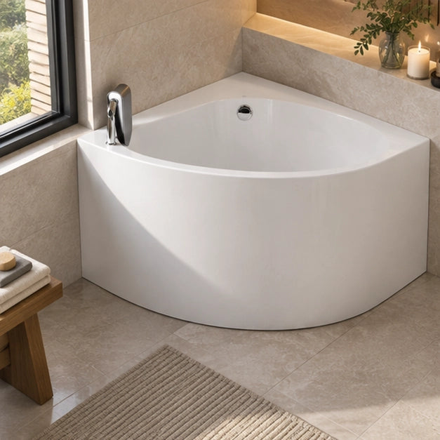 White corner soaking tub placed in bathroom corner beside window