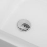 Close-up of chrome bathtub drain on white tub interior