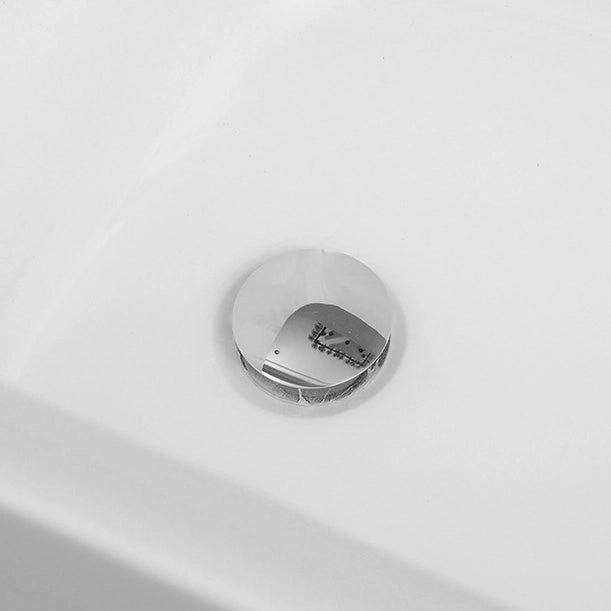 Close-up of chrome bathtub drain on white tub interior