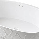 Close view of bathtub overflow hole and pop-up drain inside white tub
