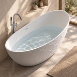 Oval embossed soaking tub filled with water beside stone bathroom wall