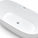 Angled interior close-up of soaking tub, overflow and drain detail view