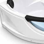 Close-up of bathtub corner, black headrest and glossy white acrylic shell