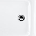 Bathtub drain detail, polished chrome drain on white tub interior