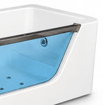 Partial shot of bathtub transparent glass side panel and stainless steel trim frame