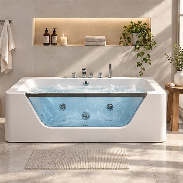 Front view white massage tub with chrome control knobs, set against bathroom recessed shelf wall