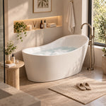 White sloped freestanding soaking tub in warm beige bathroom with lit wall niche