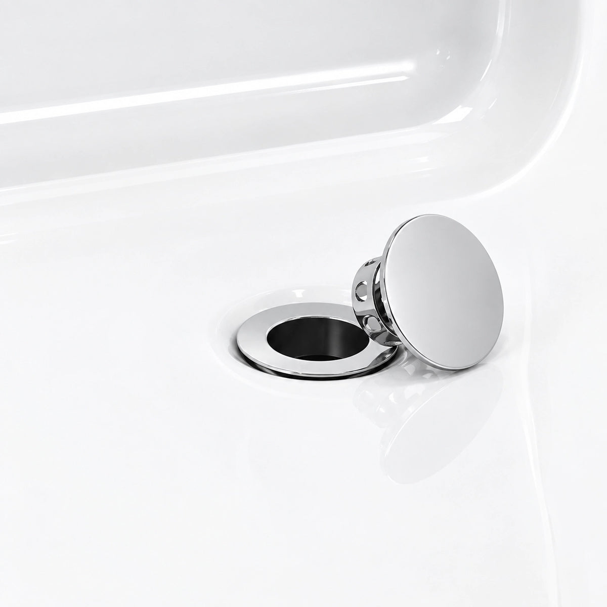 Bathtub drain close‑up, polished chrome pop‑up stopper