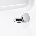 Bathtub drain close‑up, polished chrome pop‑up stopper