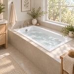White drop‑in tub in cozy window‑side bathroom with deck faucet