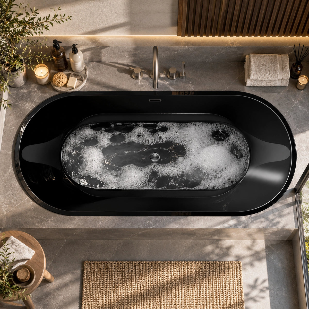 Top-down view of black oval drop-in tub set within grey stone bathroom countertop