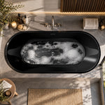 Top-down view of black oval drop-in tub set within grey stone bathroom countertop