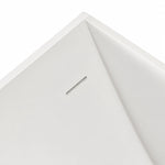 Close-up of bathtub inner corner, integrated long overflow slot on seamless solid white tub wall