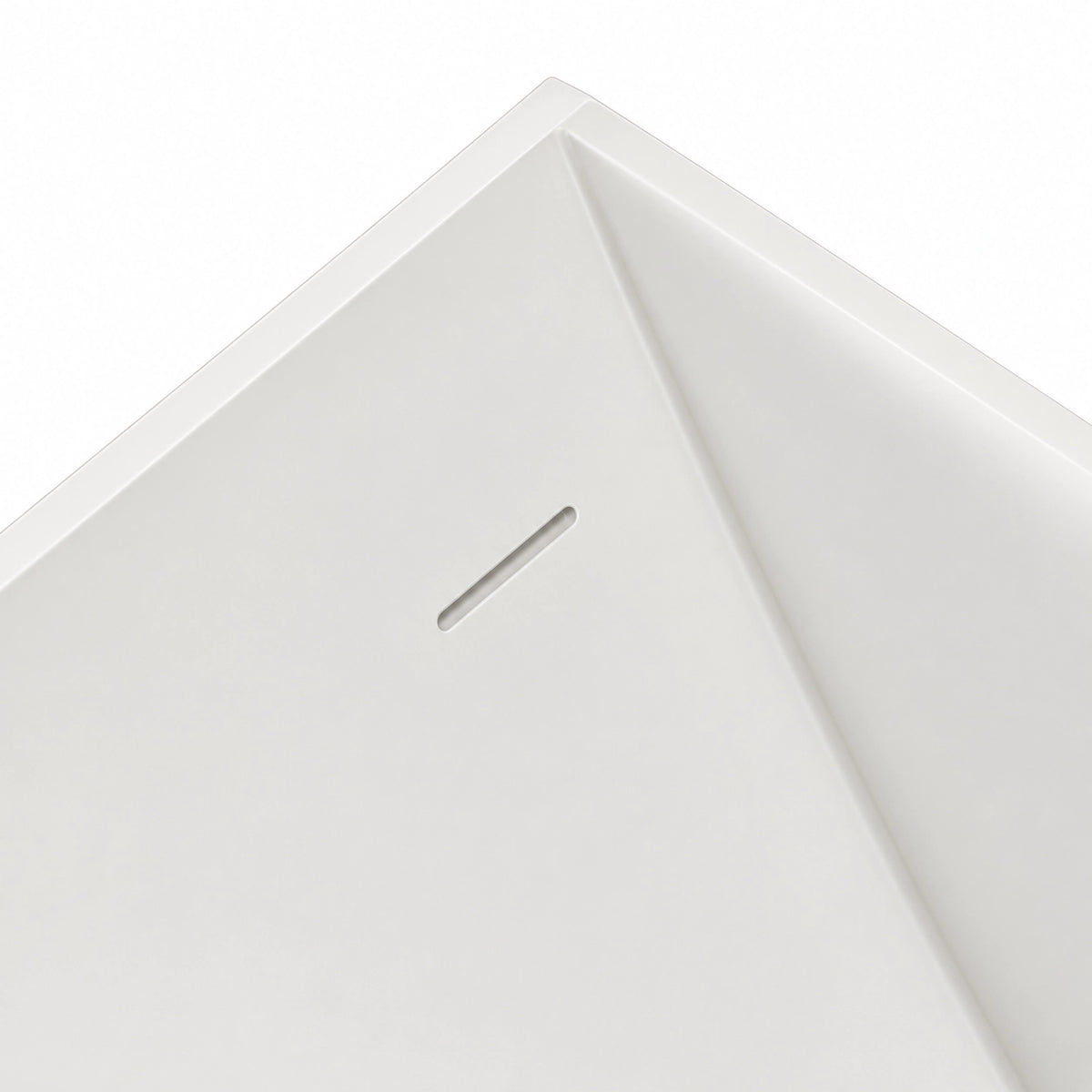 Close-up of bathtub inner corner, integrated long overflow slot on seamless solid white tub wall