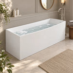 Rectangular freestanding solid surface tub inside soft-toned refined bathroom,wooden stool and decorative greenery
