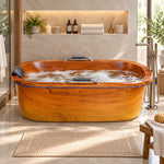 Wood grain oval freestanding acrylic bathtub with metal grab bars and bath pillow, placed in luxury bathroom with recessed niche and bath accessories