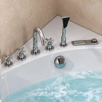 Close-up of chrome deck-mount tub faucet set, cross handle taps, handheld shower and drain knob