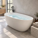 White oval freestanding bathtub in modern bathroom with grey marble wall and floor-standing faucet